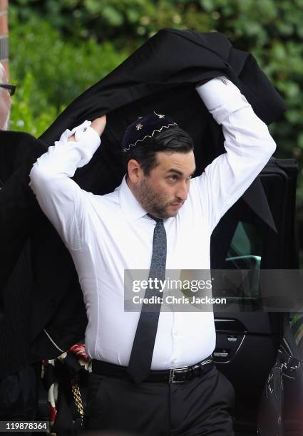 Alex Winehouse arrives for the cremation of Amy Winehouse at Golders Green Crematorium on July 26, 2011 in London, England. Winehouse was found dead...