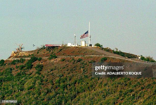 Building on the US naval base in Guantanamo, Cuba, flies an American flag at half mast 11 September 2002, in commemoration of the terrorist attacks...