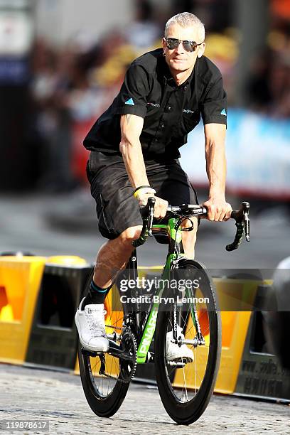 Directeur Sportif Sean Yates of Team Sky takes part in a processional lap after the twenty first and final stage of Le Tour de France 2011, from...