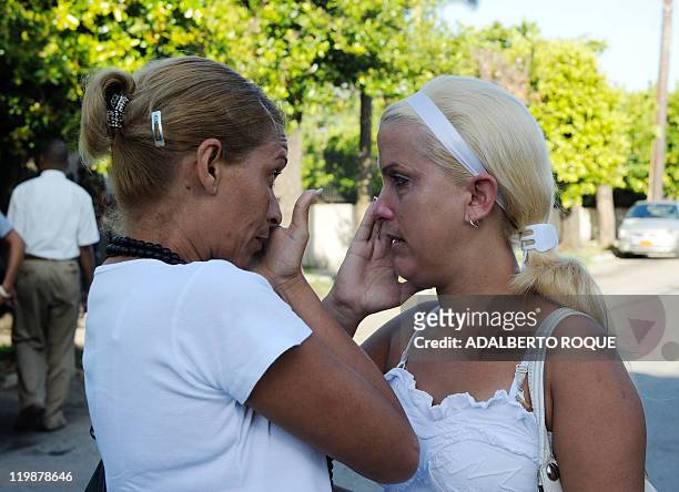 Cuban regime opponent Yusnaimy Jorge , wife of opponent doctor Darsi Ferrer, wipes her tears on June 22 in front of the court in Havana wher her...