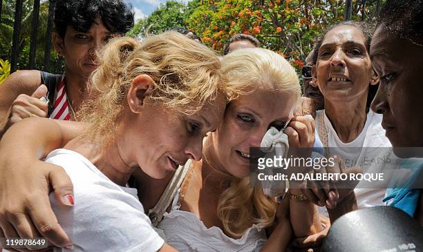 Cuban regime opponent Yusnaimy Jorge , wife of opponent doctor Darsi Ferrer, cries on June 22 in front of the court in Havana at the end of her...