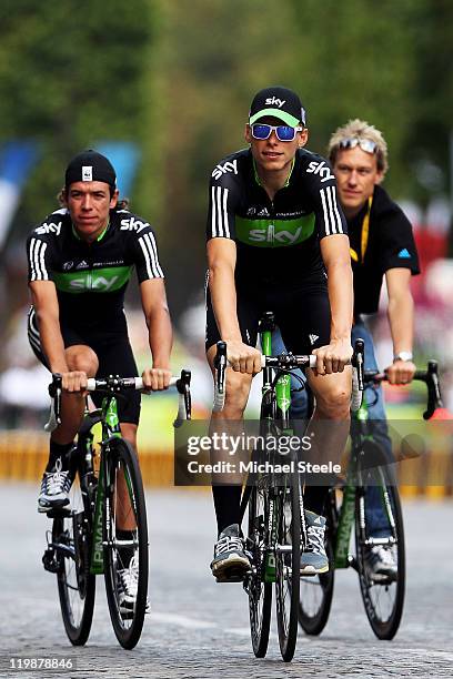 Rigoberto Uran and Christian Knees of Team SKY takes part in a victory parade after winning the green points jersey after the twenty first and final...