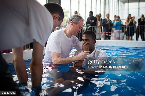 Beliver is baptised during a Jehovah's Witnesses assembly gathering 30.000 believers on July 23, 2011 in Villepinte, Paris suburb. European rights...