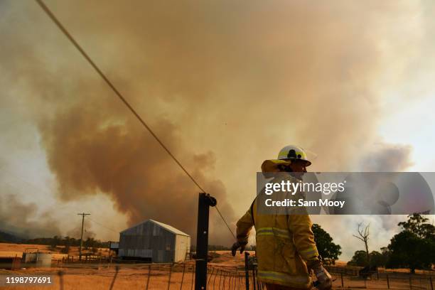 Rural Fire Service firefighter Trevor Stewart views a flank of a fire on January 11, 2020 in Tumburumba, Australia. Cooler temperatures forecast for...