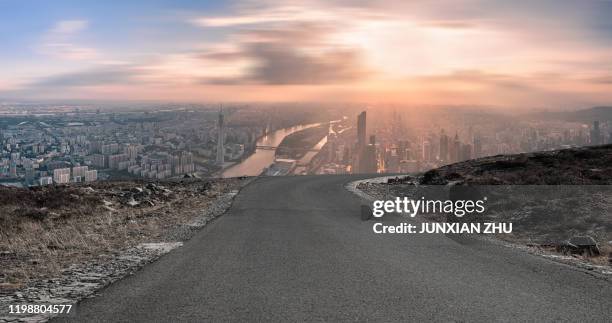 dirt road pavement and guangzhou city buildings skyline - off road stock-fotos und bilder