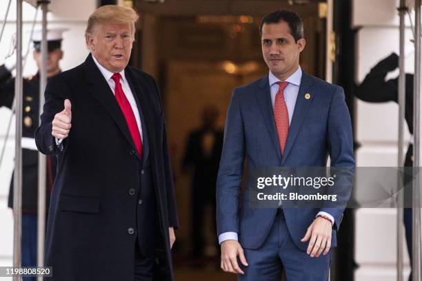 President Donald Trump and Juan Guaido, president of the National Assembly who swore himself in as the leader of Venezuela, right, stand for...