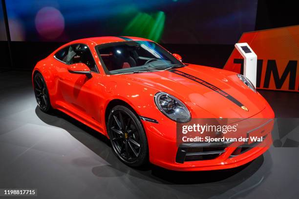 Porsche 911 Carrera 2 Coupé sports car in red on display at Brussels Expo on January 9, 2020 in Brussels, Belgium. The Porsche 992 is the eighth...