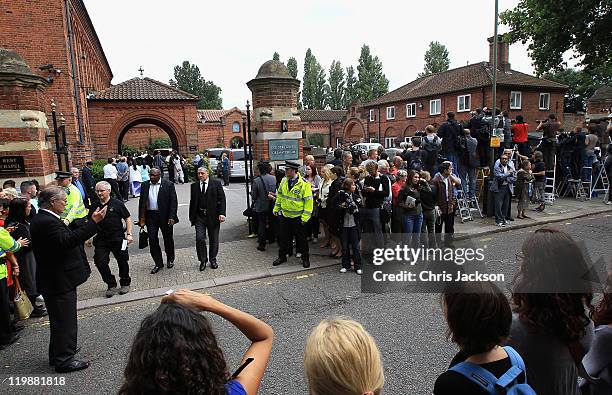 Media photograph and film guests at the cremation of Amy Winehouse at Golders Green Crematorium on July 26, 2011 in London, England. Winehouse was...