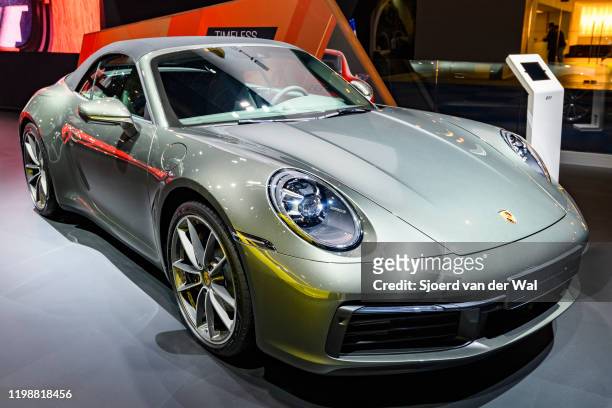 Porsche 911 Carrera 4 Cabriolet on display at Brussels Expo on January 9, 2020 in Brussels, Belgium. The Porsche 992 is the eighth generation of the...