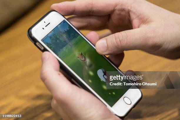 Visitor plays the Pokemon Go augmented-reality game on a smartphone during the Tokyo eSports Festa on January 11, 2020 in Tokyo, Japan. The two-day...