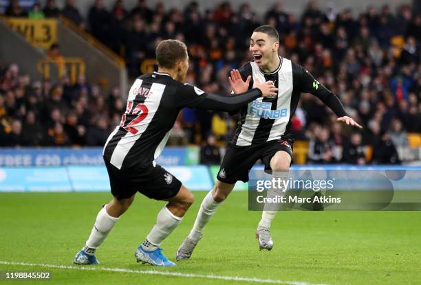 Miguel Almiron of Newcastle United celebrates with teammate Dwight Gayle after scoring his team's first goal during the Premier League match between...