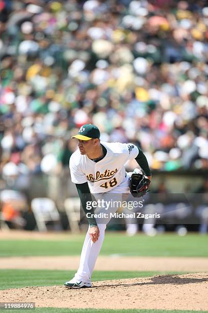 Michael Wuertz of the Oakland Athletics pitches during the game against the LA Angels at the Oakland-Alameda County Coliseum on July 16, 2011 in...