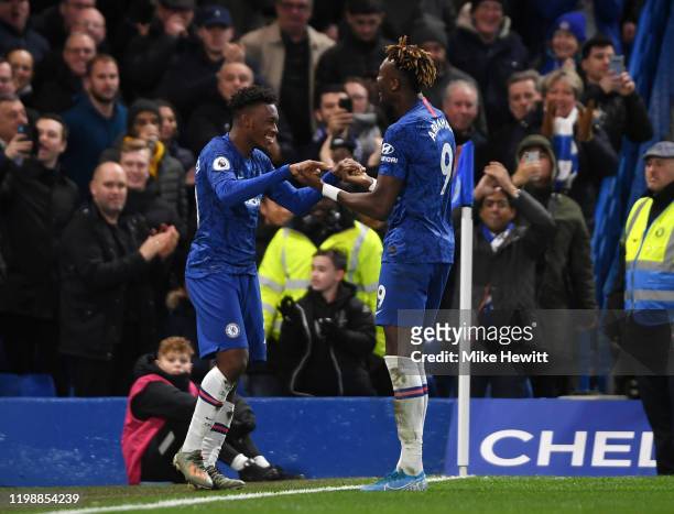 Callum Hudson-Odoi of Chelsea celebrates with teammate Tammy Abraham of Chelsea after scoring his team's third goal during the Premier League match...