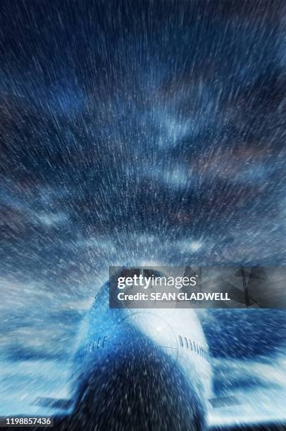 airplane flying in winter snow - airline cockpit window stock pictures, royalty-free photos & images