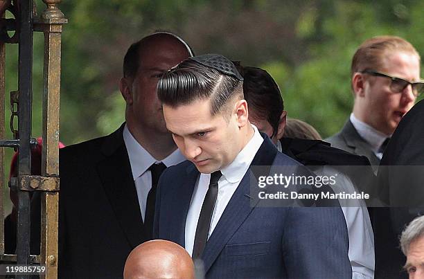 Amy Winehouse's former boyfriend Reg Traviss attends a service for her cremation at Golders Green Crematorium on July 26, 2011 in London, England.