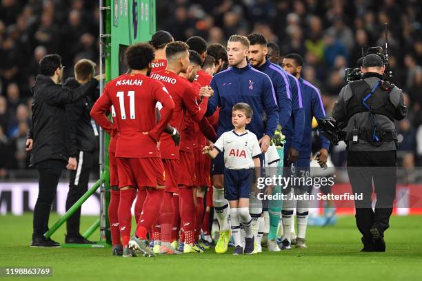 Players shake hands prior to the Premier League match between Tottenham Hotspur and Liverpool FC at Tottenham Hotspur Stadium on January 11, 2020 in...