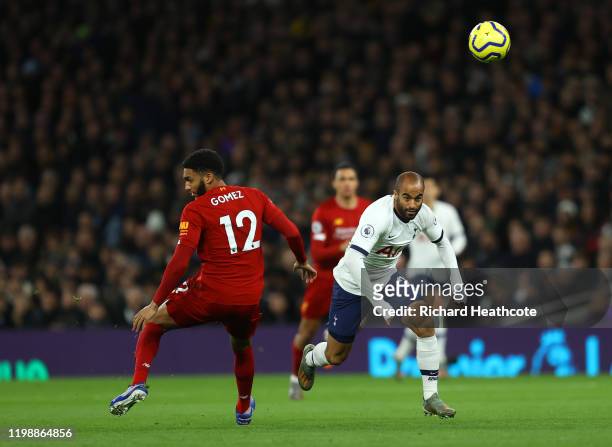 Lucas Moura of Tottenham Hotspur battles for possession with Joe Gomez of Liverpool during the Premier League match between Tottenham Hotspur and...