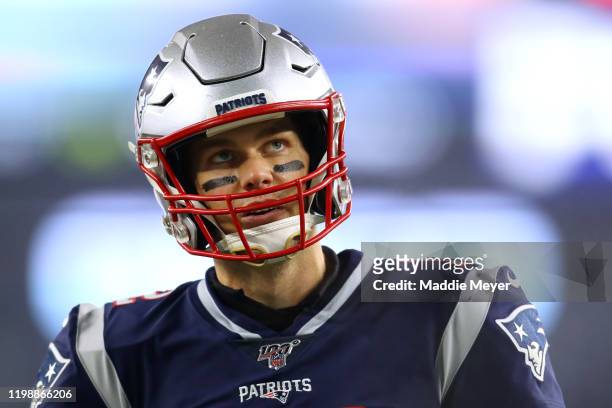 Tom Brady of the New England Patriots looks on before the AFC Wild Card Playoff game against the Tennessee Titans at Gillette Stadium on January 04,...