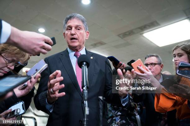 Senator Joe Manchin speaks to the press near the Senate subway following a vote in the Senate impeachment trial that acquitted President Donald Trump...