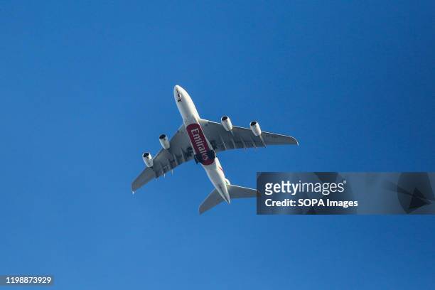 An A380 Emirates Airline with its landing gear down is seen over Westminster, London.