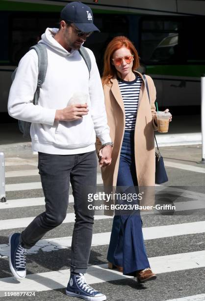 Brittany Snow and her fiance Tyler Stanaland are seen at LAX airport on February 05, 2020 in Los Angeles, California.