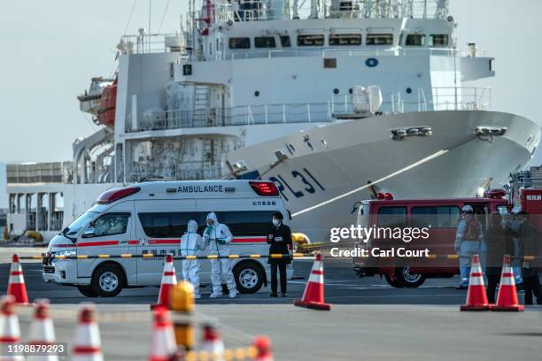 An ambulance carries a coronavirus victim from the Diamond Princess cruise ship while it is docked at Daikoku Pier where it will be resupplied and...