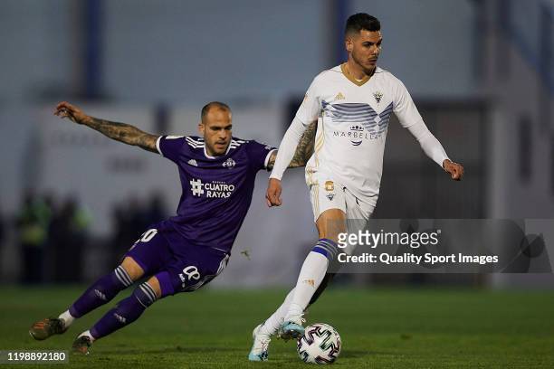 Elias Perez of Marbella FC competes for the ball with Sandro Ramirez of Real Valladolid during the Copa Del Rey first round match between Marbella FC...