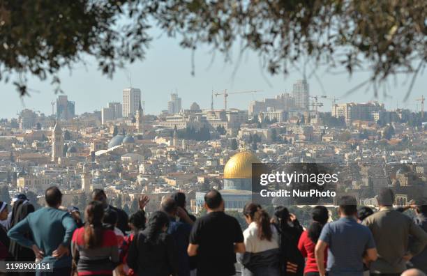 Tourists look from the Mount of Olives at the panoramic view of the Old City of Jerusalem with its Dome of the Rock mosque in the centre. On...