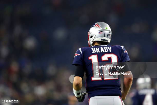 Tom Brady of the New England Patriots runs towards the bench before the AFC Wild Card Playoff game against the Tennessee Titans at Gillette Stadium...