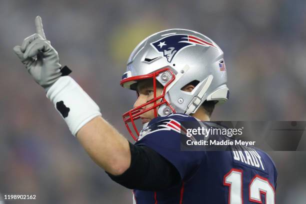 Tom Brady of the New England Patriots signals to teammates during the AFC Wild Card Playoff game against the Tennessee Titans at Gillette Stadium on...