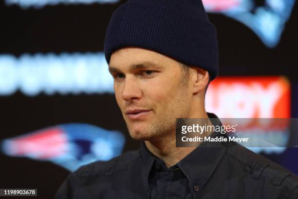 Tom Brady of the New England Patriots talks with the media during a press conference after the AFC Wild Card Playoff game against the Tennessee...