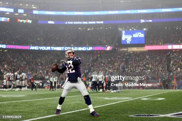 Tom Brady of the New England Patriots warms up during the AFC Wild Card Playoff game against the Tennessee Titans at Gillette Stadium on January 04,...