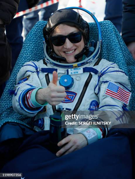 Astronaut Christina Koch gestures shortly after landing in a remote area outside the town of Dzhezkazgan , Kazakhstan, on February 6, 2020. - NASA's...