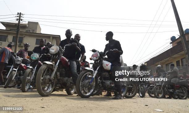 Motorbike taxis park to wait for passengers on a street in Lagos, on February 6, 2020. - Nigeria's traffic-choked economic capital Lagos state...