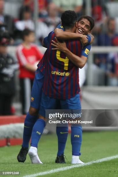 Jonathan Dos Santos of Barcelona celebrates the second goal with Thiago Alcantara during the Audi Cup match between FC Barcelona and International de...