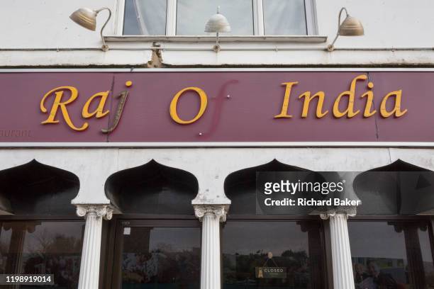 With the missing letter 'f', an exterior of the 'Raj of India', Indian restaurant, a fading exterior for eat-in or takeaway south-Asian foods in the...