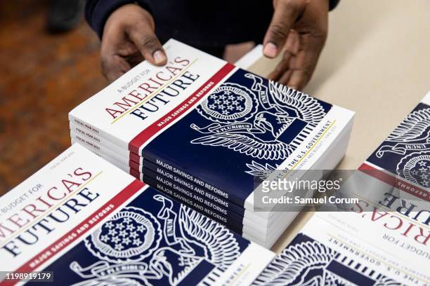 Printer loads sections of US President Donald Trump's proposed budget for the U.S. Government for the 2021 Fiscal Year onto a cart at the Government...