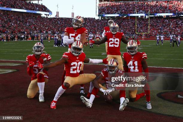 Richard Sherman of the San Francisco 49ers celebrates with teammates after intercepting a pass by Kirk Cousins of the Minnesota Vikings in the third...