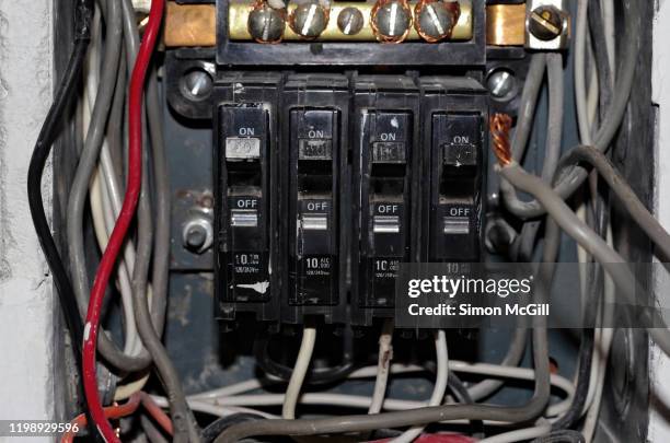 dismantled fuse box and wiring under repair on the interior wall of a house - fuse box ストックフォトと画像