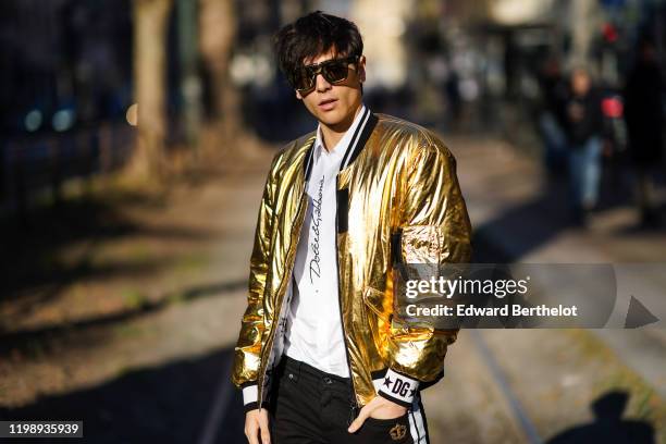 Edoardo Esposito "Sespo", Youtube and TikTok influencer, wears sunglasses, a golden shiny bomber jacket, a white t-shirt, outside Dolce Gabbana,...