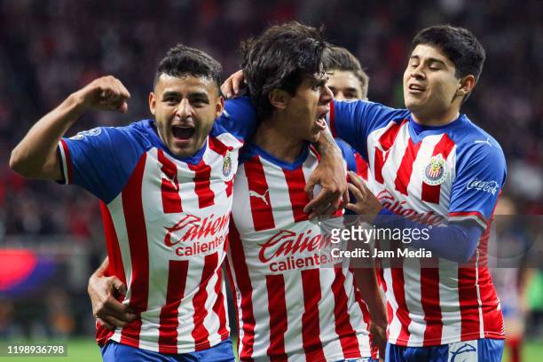 Jose Macias of Chivas celebrates after scoring the second goal of his team with teammates Ernesto Vega and Javier Eduardo Lopez during the 1st round...