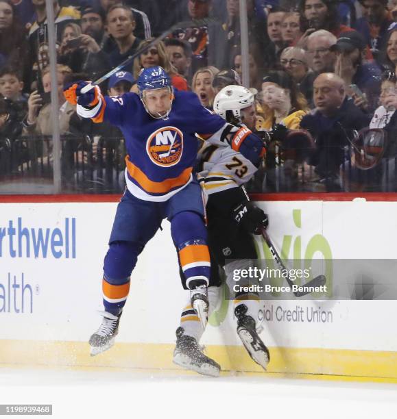 Leo Komarov of the New York Islanders steps into Charlie McAvoy of the Boston Bruins during the third period at the Barclays Center on January 11,...