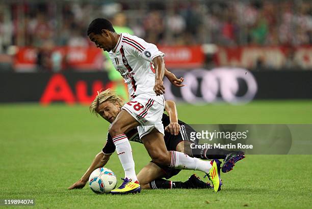 Anatoliy Tymoshchuk of Muenchen and Urby Emanuelson of Milan battle for the ball during the Audi Cup match between FC Bayern Muenchen and AC Milan at...