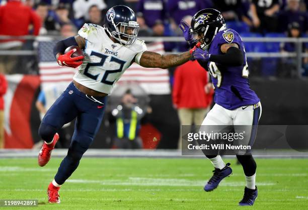 Derrick Henry of the Tennessee Titans carries the ball against Earl Thomas of the Baltimore Ravens during the AFC Divisional Playoff game at M&T Bank...