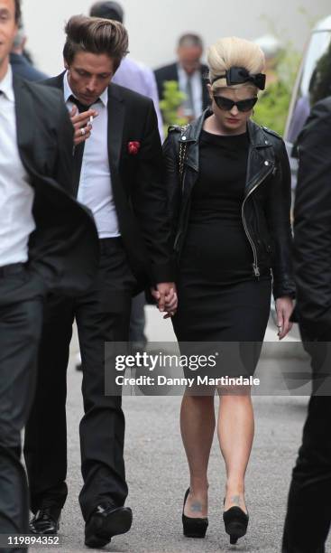 Kelly Osbourne is comforted by a friend at the wake of singer Amy Winehouse at Southgate Centre For Judaism on July 26, 2011 in London, England.