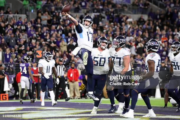 Ryan Tannehill of the Tennessee Titans celebrates after rushing for a 1-yard touchdown during the third quarter against the Baltimore Ravens in the...