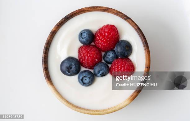 top view of yogurt with raspberry and blueberry - blueberries in bowl stock pictures, royalty-free photos & images