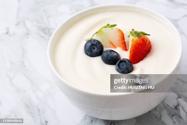 bowl of yogurt and fresh berries on white. fresh yogurt, strawberries, blueberries, handmade - greek yogurt stock pictures, royalty-free photos & images