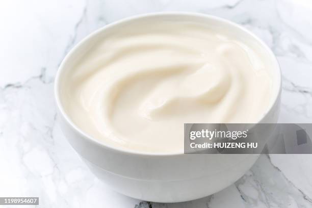 fresh yogurt in a bowl, closeup - milk swirl stock pictures, royalty-free photos & images