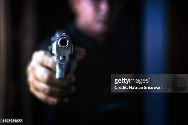 armed robbers used the gun to robbery. - arm pointing stock pictures, royalty-free photos & images